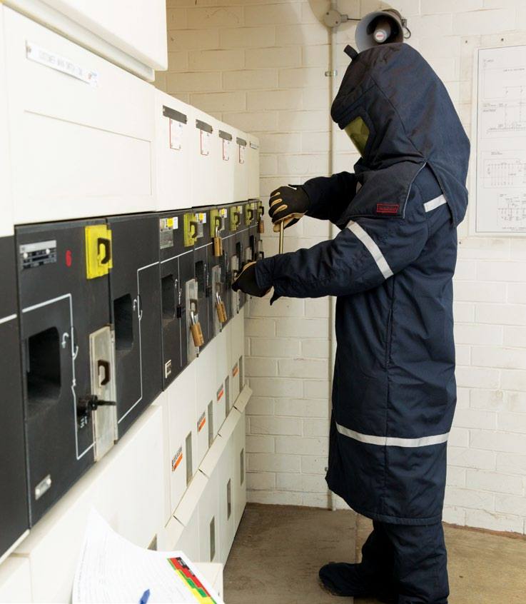 Foster’s electrician in arc-flash PPE switching at a switchboard